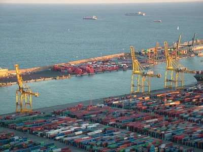 A photograph of a dock and container ships